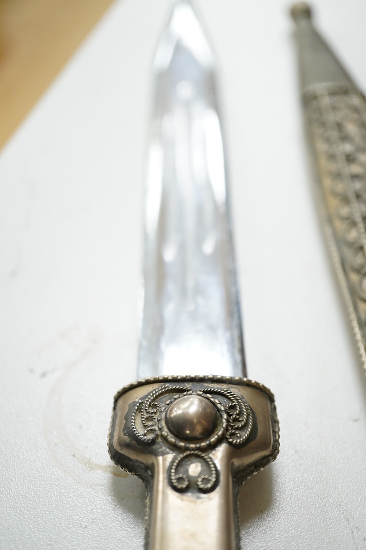 An African hardwood throwing club together with a painted mask and a Caucasian style dagger kindjal, largest 34cm high